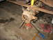 1995 Ford C-350 (Centurion Conversions) - Front axle assembly, likely from a Ford C-350, undergoing repair with tools scattered around.