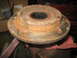 1995 Ford C-350 (Centurion Conversions) - A heavily rusted wheel hub assembly is clamped in a vise, with a red cloth underneath.