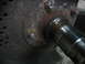 1995 Ford C-350 (Centurion Conversions) - A close-up view of a corroded metal part, possibly from a vehicle's axle or hub assembly.