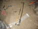 1995 Ford C-350 (Centurion Conversions) - Various automotive parts and tools are laid out on a garage floor, suggesting a repair or maintenance operation.