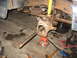 1995 Ford C-350 (Centurion Conversions) - Front axle components are disassembled and supported by jack stands, indicating a repair or rebuild process.