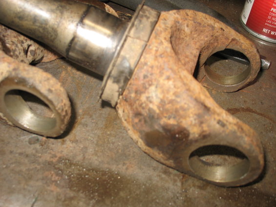 Rusted front axle part with metal sleeve