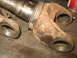 1995 Ford C-350 (Centurion Conversions) - Close-up of a heavily rusted front axle component, likely part of a rebuild project.