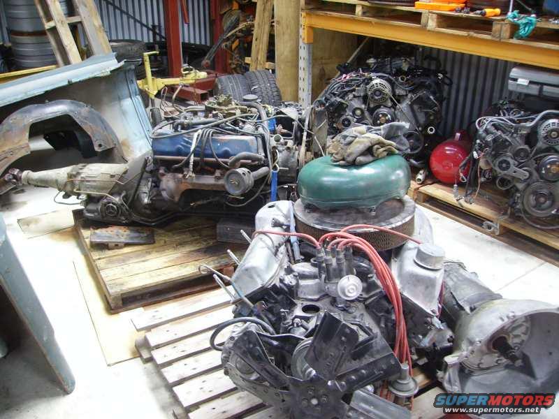 Engines and transmissions on pallets in a workshop
