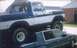 1978 Ford Bronco - A lifted 1978 Ford Bronco is parked on top of another vehicle.