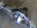 1996 Ford Bronco - Close-up view of a polished metal suspension component, likely a differential housing, showing intricate welding and bolt patterns.