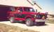 1984 Ford Bronco - This two-tone Ford Bronco is parked in a driveway with a house in the background.