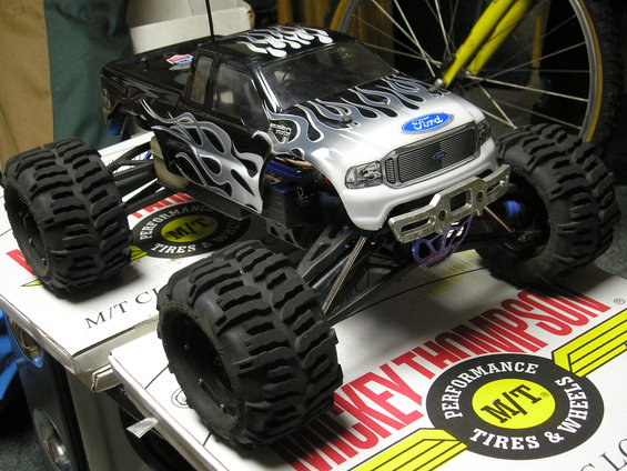 Remote control monster truck with flame decals and Ford logo on the grille