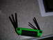 2002 BMW M3 - A green allen wrench set and an air filter are shown on a surface with a document.