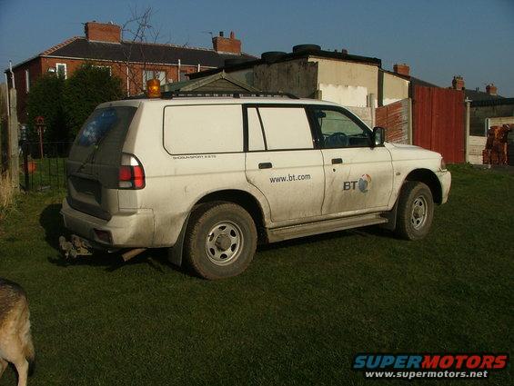 White panel van with "www.bt.com" and "BT" logo on the side. It has an orange beacon on the roof