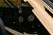 1986 Ford Bronco - Close-up view of vehicle frame components, including clevis mounts and wiring, with beige trim.