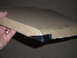 1998 BMW R1100GS ABS - A hand holds a cardboard box with black plastic trim, possibly a motorcycle part.