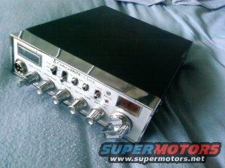 Cobra 148 GTL CB radio with chrome accents and multiple knobs, placed on a blue fabric surface