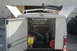 2006 Honda CBR-RR - Rear view of a white utility truck bed loaded with various tools and equipment, with doors ajar.