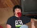 1980 Ford Bronco - A person sits on a couch with red licorice in their mouth, in front of a television set.