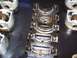 1974 Ford F-100 - Several engine crankshaft bearings and pistons are visible in this close-up shot.