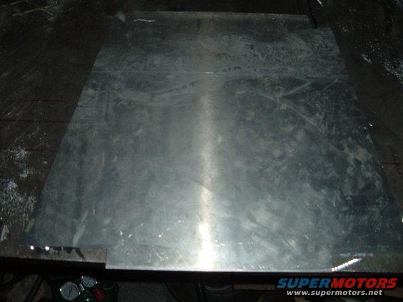 Sheet metal on a workbench, possibly for a motorcycle rack