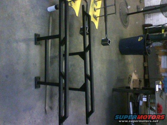 Pair of black metal rock sliders mounted on a wall