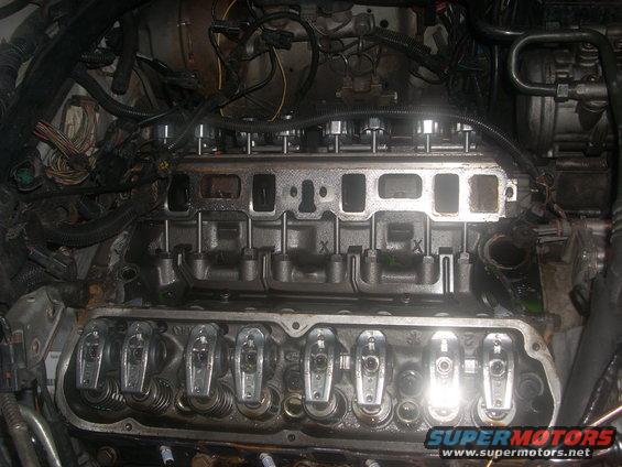 Engine with valve covers off, showing rocker arms and intake manifold