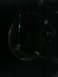 2001 Nissan Frontier - A close-up view of a vehicle's headlight assembly is visible in the darkness.