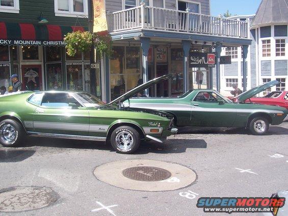 Green 1971 Ford Mustang Mach 1 side view with hood open