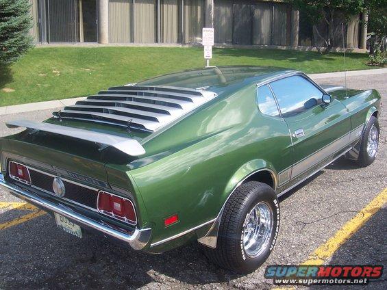 Green 1971 Ford Mustang Mach 1 with rear louvers and spoiler, 3q-front view
