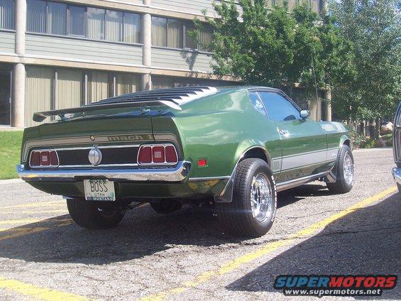 Green 1973 Ford Mustang Mach 1 rear view with a 'BOSS' license plate
