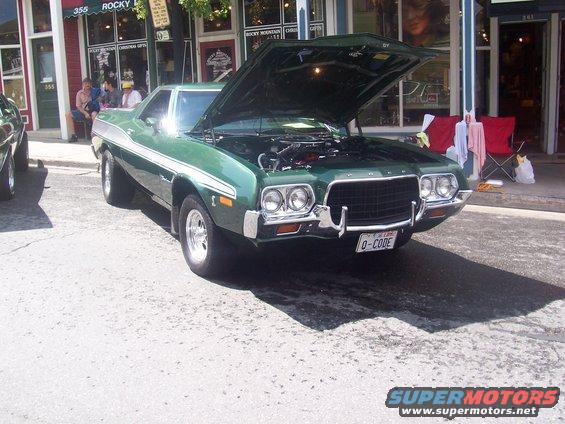 Green 1972 Ford Ranchero with hood open, showing engine