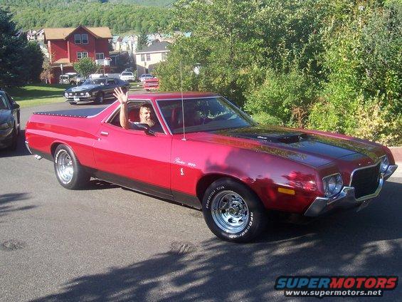 Red 1973 Ford Ranchero with a driver waving from the window