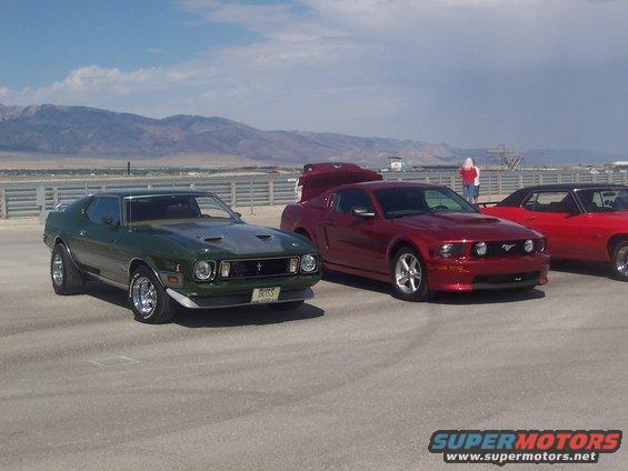 Green 1971 muscle car with a silver hood scoop and "BOSS" plate