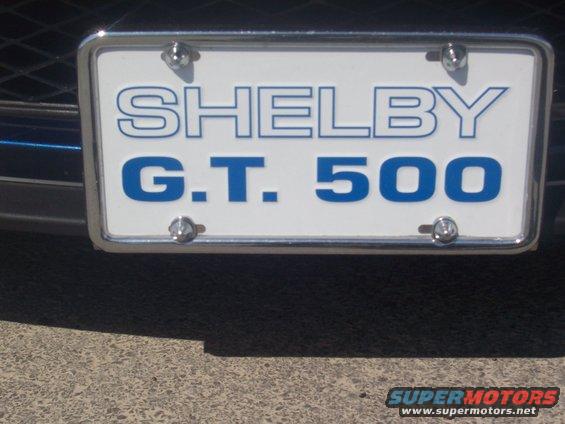License plate frame with blue text 'SHELBY G.T. 500' on white background