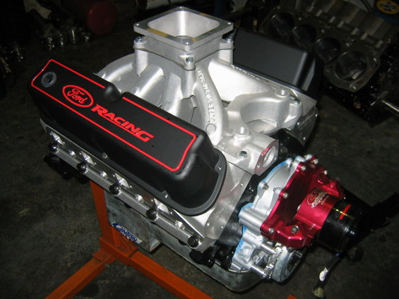 Ford Racing valve cover on an engine block with a silver intake manifold