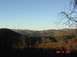 1995 Ford Bronco - View of rolling hills and mountains on a clear day, with bare branches in the foreground.