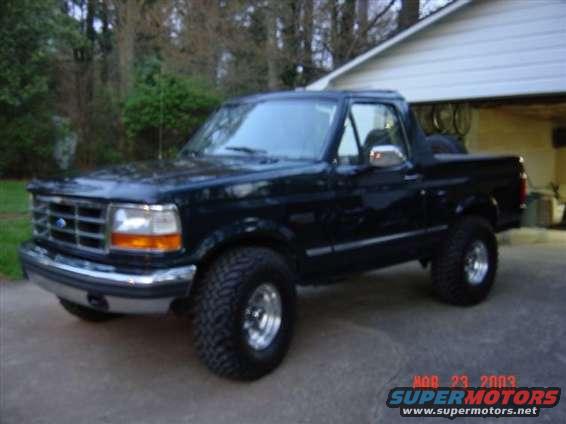 Black Ford Bronco parked outside a house