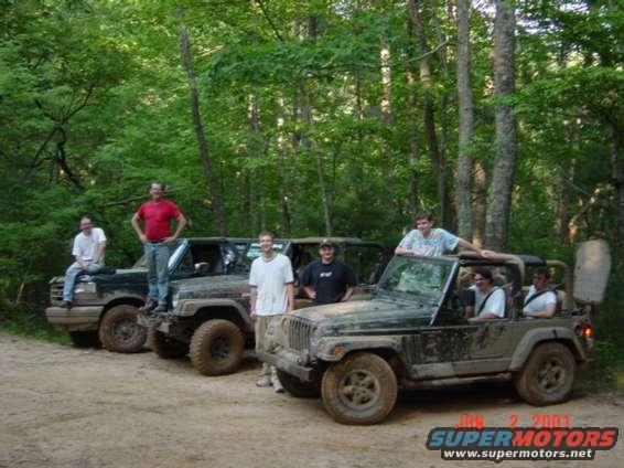 Group of people with off-road vehicles in a wooded area