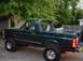 1995 Ford Bronco - This lifted 1995 Ford Bronco is shown from a three-quarter front angle, highlighting its off-road modifications.