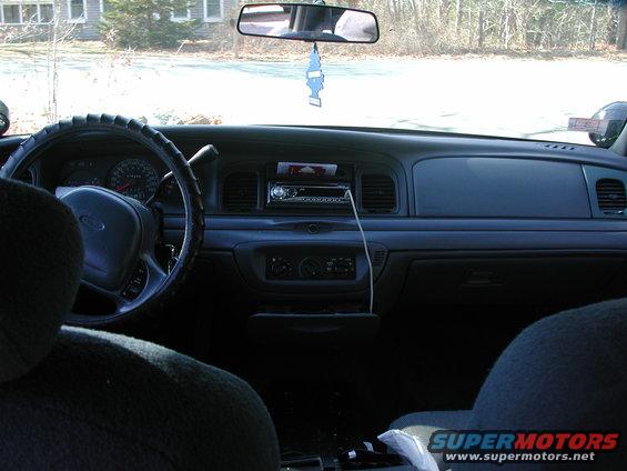 Interior view of a 1998 Ford Crown Victoria showing the dashboard, steering wheel, and radio