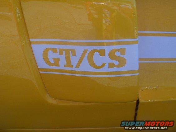 Yellow car side panel with white GT/CS stripe