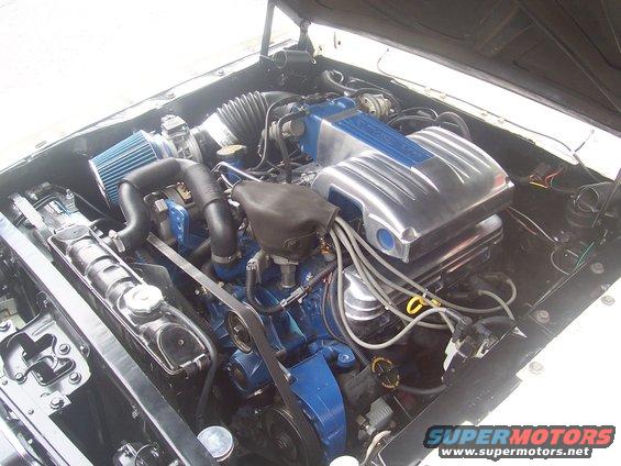 Engine bay with blue engine block, chrome intake manifold, and blue air filter