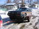1999 Ford Taurus - A dark blue station wagon with wood paneling is being towed on a U-Haul trailer through a snowy area.