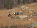 1991 Ford F-150 - People and off-road vehicles are gathered on a dirt trail in a wooded area.