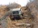1991 Ford F-150 - A Jeep Wrangler navigates a challenging rocky incline on an off-road trail.