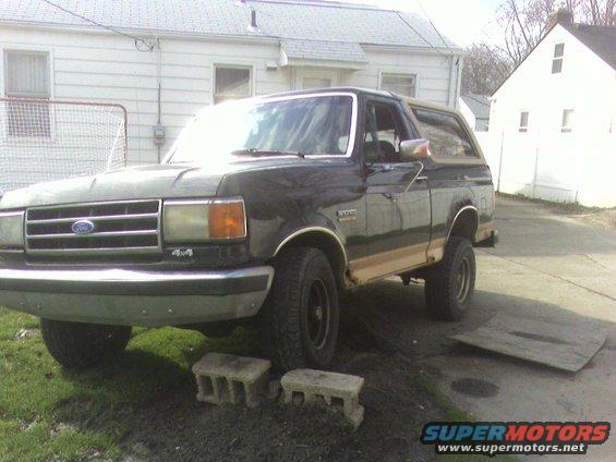 Black Ford Bronco parked in a driveway with a soccer net in the background