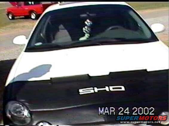 1997 Ford Taurus SHO front view with a red pickup truck in the background