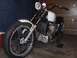 1978 Honda CB500T - A custom motorcycle is parked indoors, showing its front wheel and engine details.