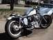 1978 Honda CB500T - A silver motorcycle is parked in front of a silver car, with a tree and houses in the background.