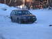 1999 Ford Taurus - This Oldsmobile station wagon is parked in a snowy area with a building in the background.