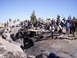 1989 Ford Bronco - A group watches as a custom off-road vehicle tackles a challenging rock formation on a sunny day.