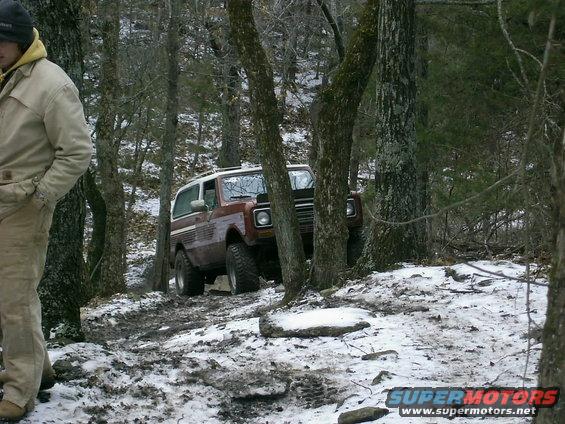 Brown SUV with white top on snowy trail, 1970s styling