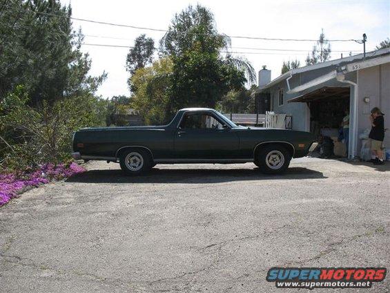 Dark green Ford Ranchero pickup truck parked in driveway